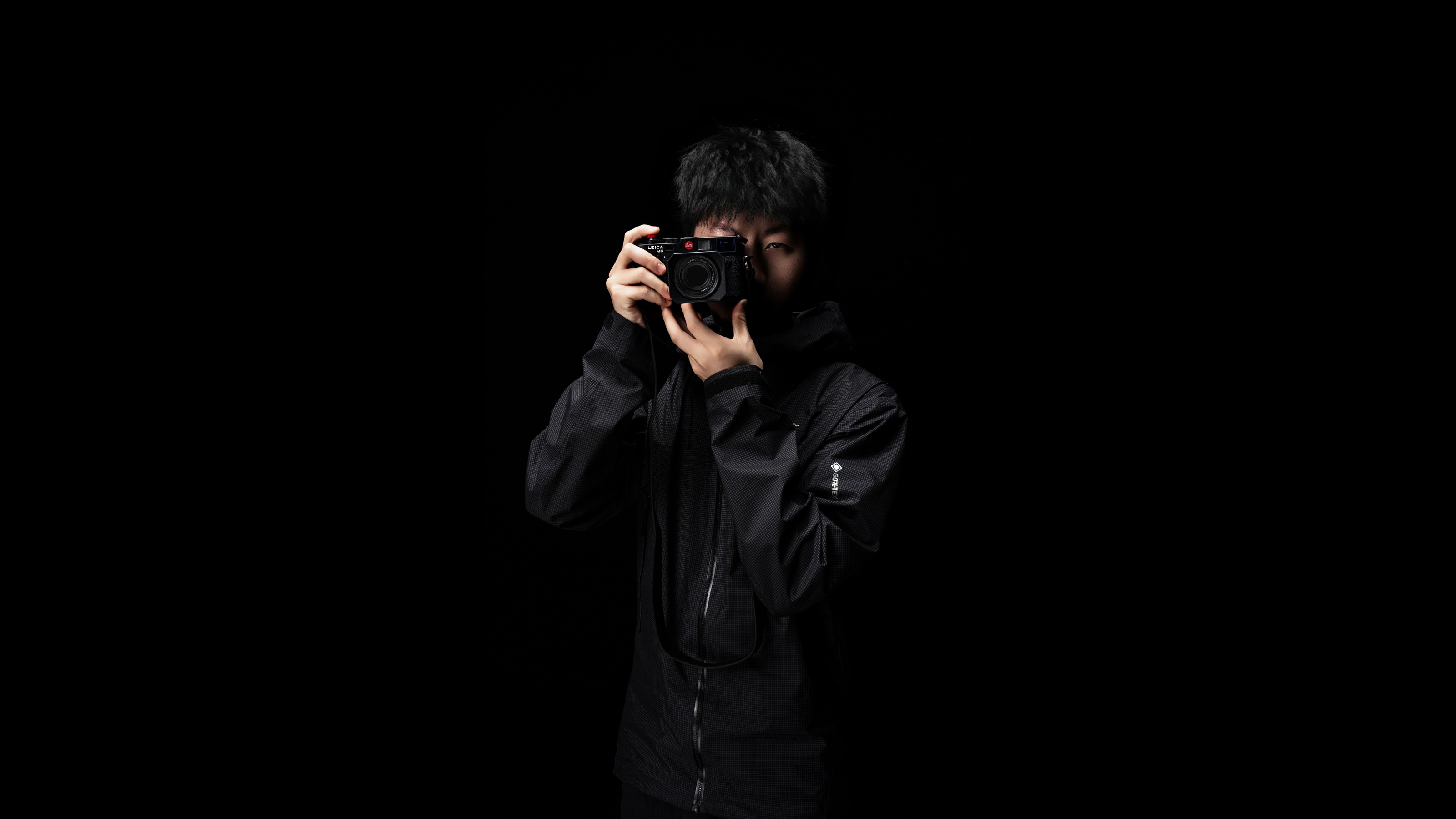 Portrait of Jin Qihuan holding a camera